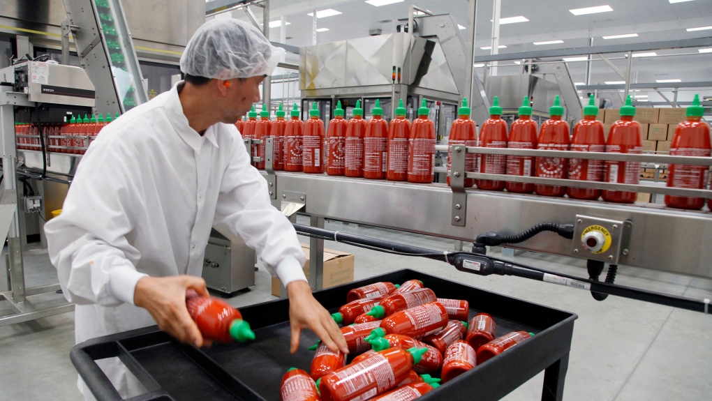 In this Oct 29, 2013 photo, Sriracha chili sauce is produced at the Huy Fong Foods factory in Irwindale, Calif. (AP Photo/Nick Ut, File)