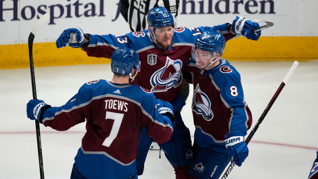 Colorado Avalanche defenceman Cale Makar, right, celebrates his goal against the Tampa Bay Lightning with right wing Valeri Nichushkin, centre, and defenseman Devon Toews during the third period of Game 5 of the NHL hockey Stanley Cup Final, Friday, June 24, 2022, in Denver. (AP Photo/David Zalubowski)