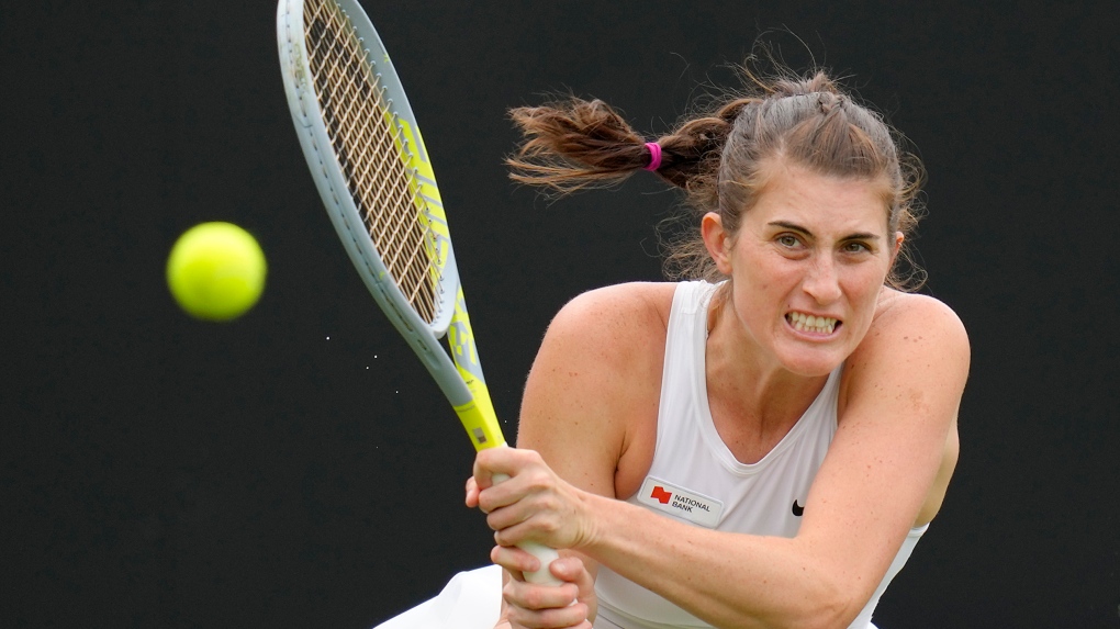 Rebecca Marino of Canada plays a return to Camila Giorgi of Italy during their singles tennis match at the Eastbourne International tennis tournament in Eastbourne, England, Tuesday, June 21, 2022. (AP Photo/Kirsty Wigglesworth)