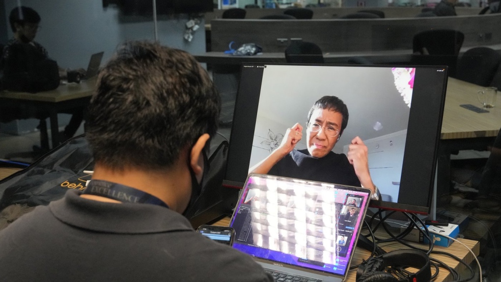 A staff member of Rappler monitors as Filipino journalist and Nobel Peace Prize winner Maria Ressa talks during a zoom meeting as seen inside their office in Pasig city, Philippines, June 29, 2022. (AP Photo/Aaron Favila)