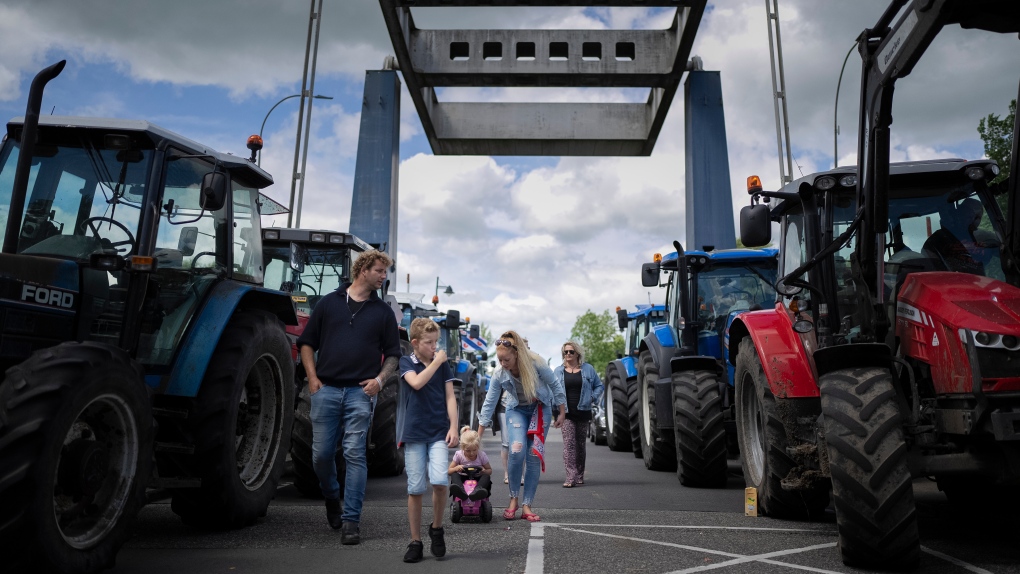 Protesting farmers block a draw bridge at a lock in the Princess Margriet canal, preventing all ship traffic from passing in Gaarkeuken, northern Netherlands, Monday, July 4, 2022.