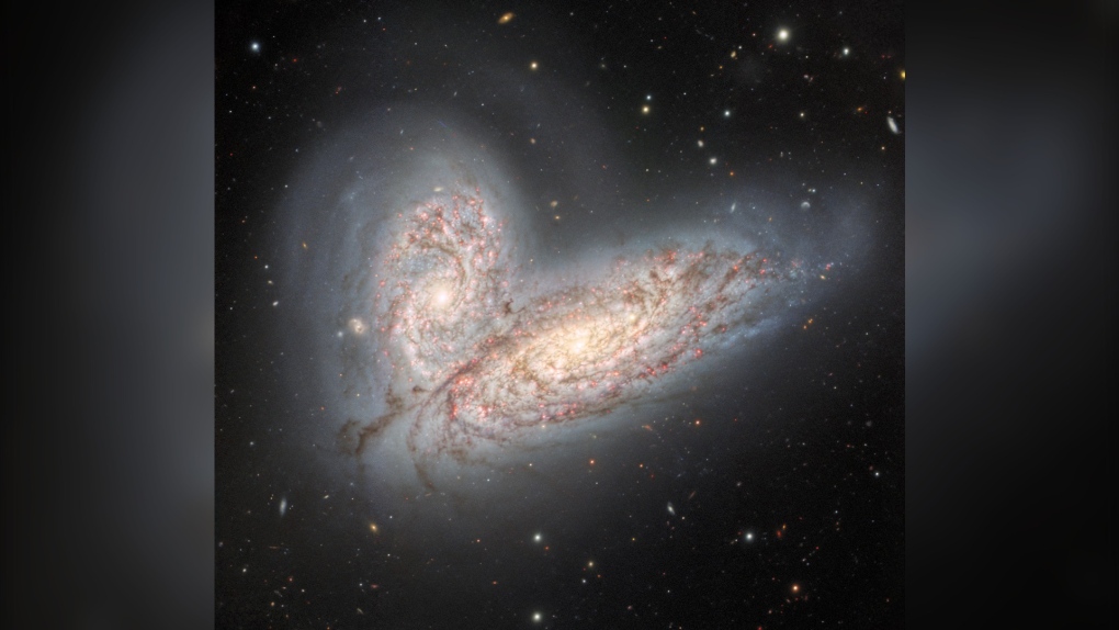 This image from the Gemini North telescope in Hawaii reveals a pair of interacting spiral galaxies — NGC 4568 (bottom) and NGC 4567 (top) — as they begin to clash and merge. (International Gemini Observatory/NOIRLab/NSF/AURA/CNN)