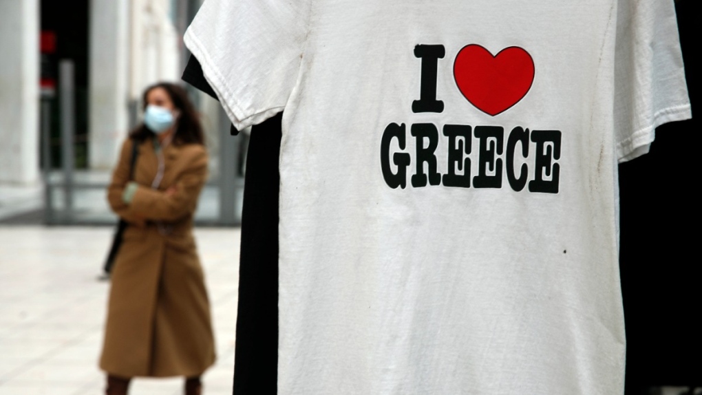 A tourist T-shirt is hung on a kiosk at Syntagma square in Athens, Greece, on Dec. 15, 2020. (Thanassis Stavrakis / AP) 