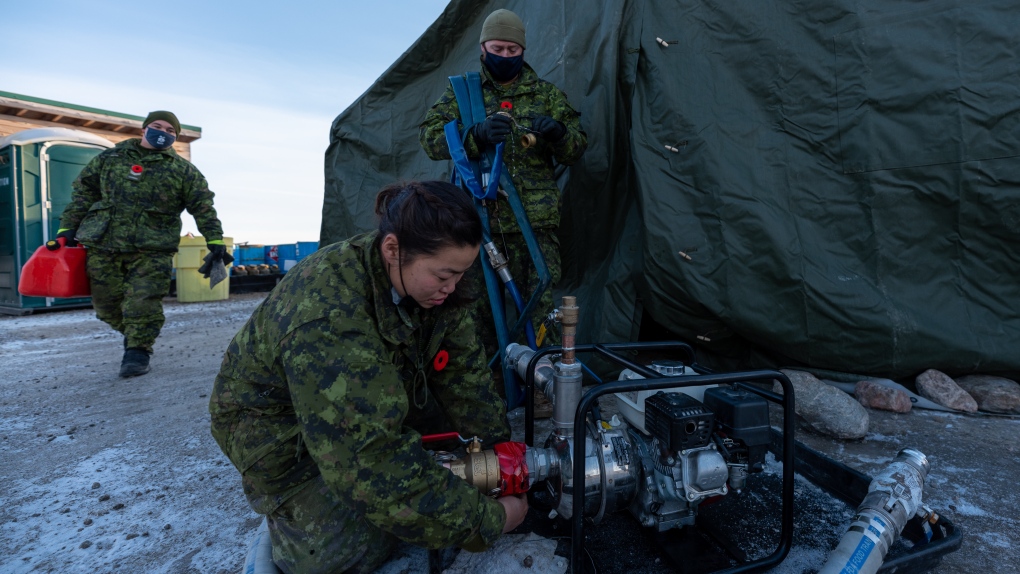 Members of the Canadian Armed Forces ready a water pump in Iqaluit, Nunavut, on Wednesday, November 10, 2021. THE CANADIAN PRESS/Dustin Patar