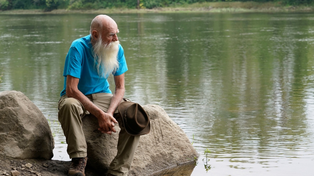 FILE -- David Lidstone, 81, sits for a photograph near the Merrimack River, Tuesday, Aug. 10, 2021, in Boscawen, N.H. (AP Photo/Steven Senne, File)