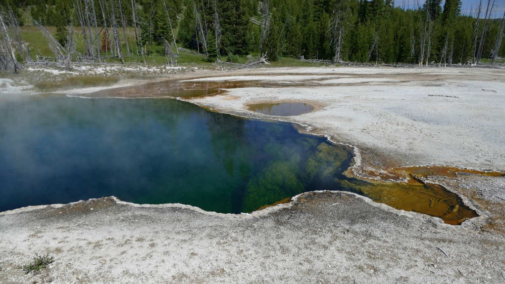 In this photo provided by the National Park Service is the Abyss Pool hot spring in the southern part of Yellowstone National Park, Wy., in June 2015. (Diane Renkin/National Park Service via AP)