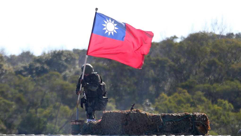 In this Jan. 19, 2021, file photo, a soldier holds a Taiwanese flag during a military exercise aimed at repelling an attack from China in Hsinchu County, northern Taiwan. (AP Photo/Chiang Ying-ying, File)