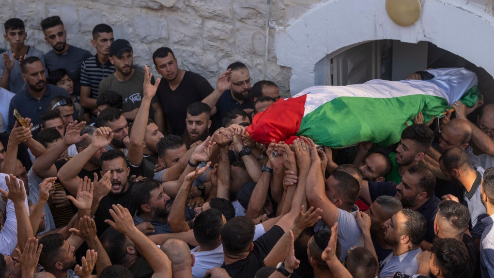 Mourners carry the body of Salah Sawafta, 58 during his funeral in the West Bank city of Tubas, Friday, Aug. 19, 2022. Israeli forces shot and killed Sawafta during an arrest raid in the occupied West Bank on Friday, according to his brother, who said he was walking home when a bullet struck him in the head as Israeli forces clashed with Palestinian youths. (AP Photo/Nasser Nasser)