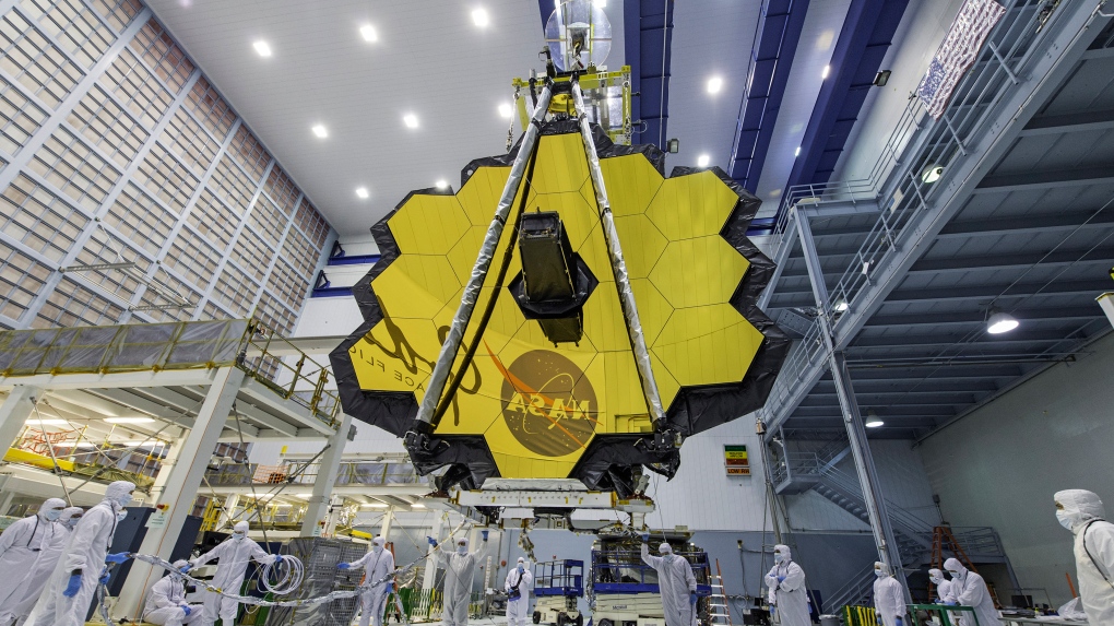 In this April 13, 2017 photo provided by NASA, technicians lift the mirror of the James Webb Space Telescope using a crane at the Goddard Space Flight Center in Greenbelt, Md. (Laura Betz/NASA via AP, File)