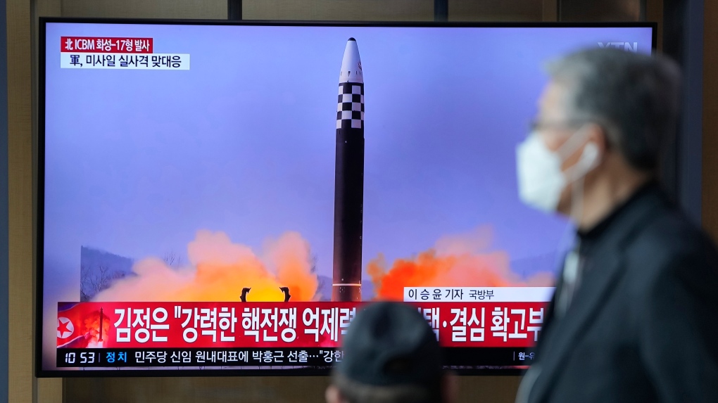 FILE - People watch a television screen showing a news program reporting about North Korea's intercontinental ballistic missile (ICBM) at a train station in Seoul, South Korea, Friday, March 25, 2022. (AP Photo/Lee Jin-man, File)