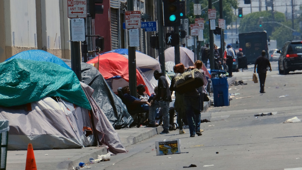 In this May 30, 2019 file photo, tents housing homeless line a street in downtown Los Angeles. The Los Angeles City Council has voted to ban homeless encampments within 500 feet of schools and daycare centers. The council voted Tuesday, Aug. 9, 2022, to broaden an existing ban on sleeping or camping near the facilities. (AP Photo/Richard Vogel, File)