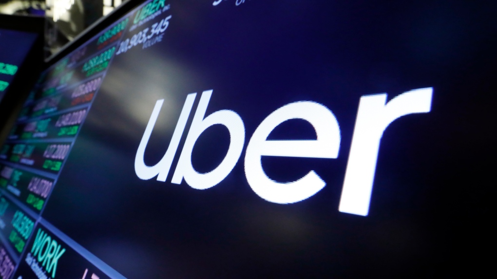 In this Aug. 16, 2019 file photo, the logo for Uber appears above a trading post on the floor of the New York Stock Exchange. (AP Photo/Richard Drew, File)