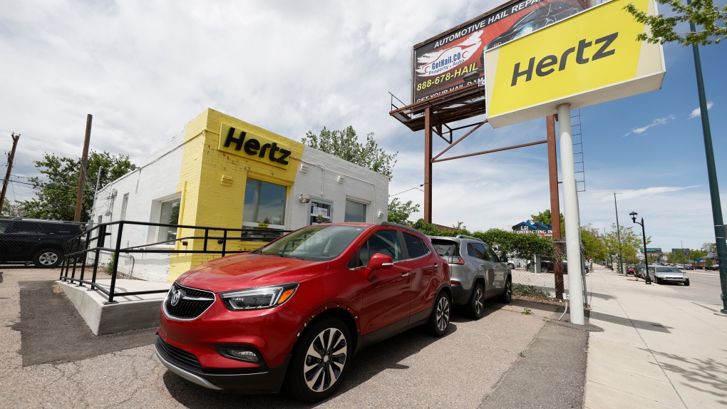 This May 23, 2020, photo shows rental vehicles parked outside a closed Hertz car rental office in south Denver. (AP Photo/David Zalubowski, file)
