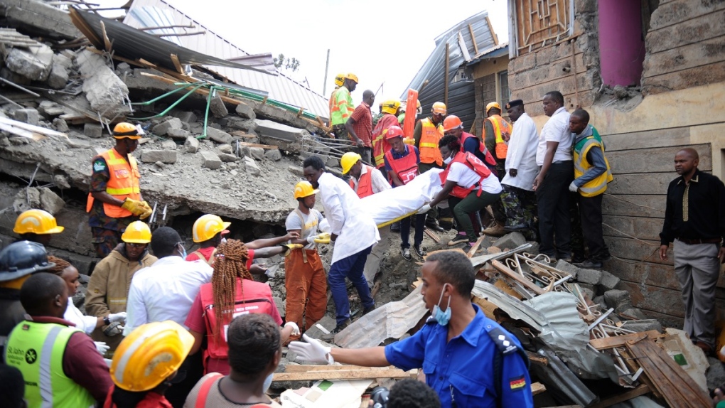 Rescuers search through a multi-storey collapsed apartment building in Kirigiti, Kiambu County, Kenya, on Sept. 26, 2022. (John Muchucha / AP)