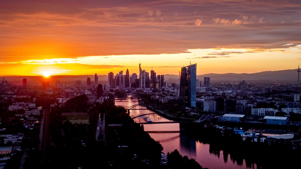 The sun sets over the banking district in Frankfurt, Germany, Sunday, Sept. 25, 2022. (AP Photo/Michael Probst)