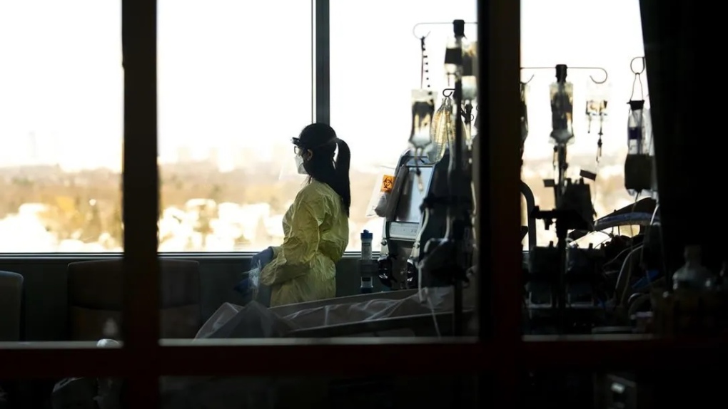 A registered nurse takes a moment to look outside while attending to a ventilated COVID-19 patient in the intensive care unit at the Humber River Hospital during the COVID-19 pandemic in Toronto on January 25, 2022. Nathan Denette / THE CANADIAN PRESS