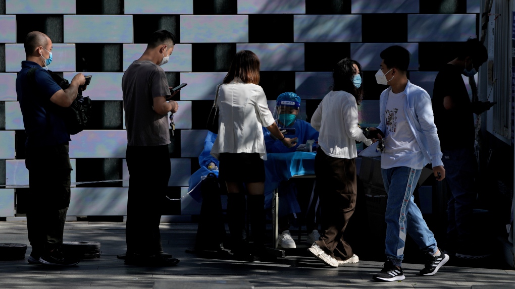 Residents line up to register to get their routine COVID-19 throat swabs at a coronavirus testing site in Beijing, Monday, Sept. 5, 2022. (AP Photo/Andy Wong)