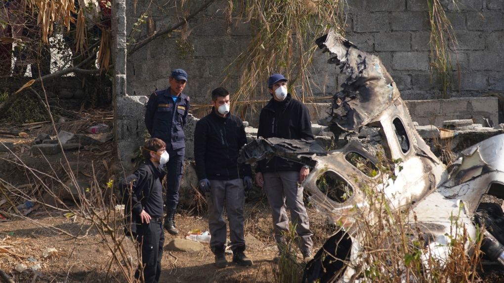 French investigators inspect the wreckage of a passenger plane at the crash site, in Pokhara, Nepal, Wednesday, Jan.18, 2023. Nepalese authorities are returning to families the bodies of plane crash victims and are sending the aircraft's data recorder to France for analysis as they try to determine what caused the country's deadliest air accident in 30 years. The flight plummeted into a gorge on Sunday while on approach to the newly opened Pokhara International Airport in the foothills of the Himalayas, killing all 72 aboard. (AP Photo/Yunish Gurung)