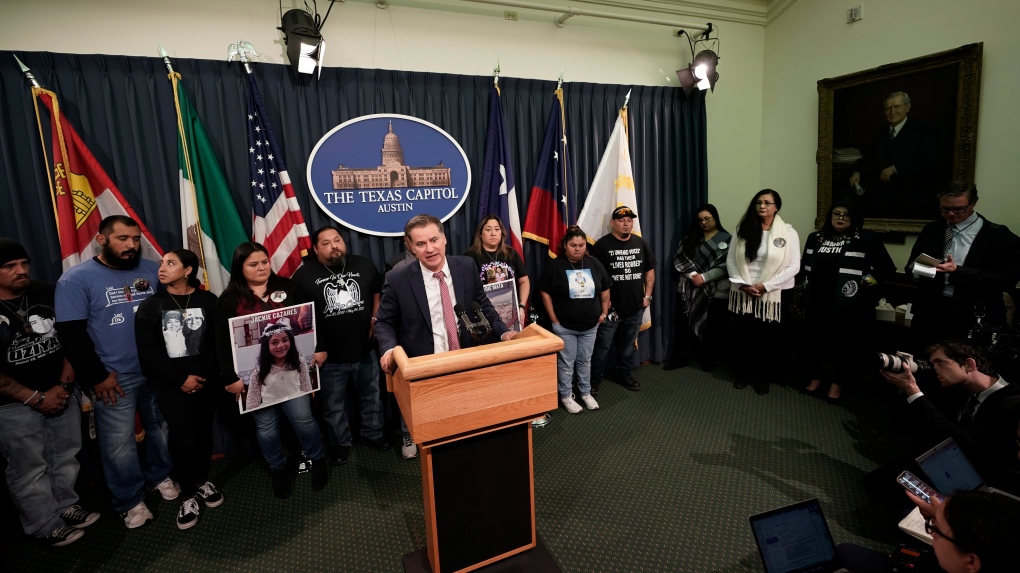 Family of those killed by a gunman at Robb Elementary School in Uvalde, Texas, and from the school shooting at Santa Fe, Texas, stand with Texas State Sen. Roland Gutierrez during a news conference at the Texas Capitol in Austin, Texas, Tuesday, Jan. 24, 2023. Gutierrez says he is filing legislation in the wake of Texas' rising gun violence. (AP Photo/Eric Gay)