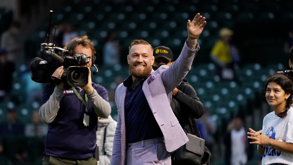 Conor McGregor waves to fans at a baseball game in Chicago, on Sept. 21, 2021. (Charles Rex Arbogast / AP) 