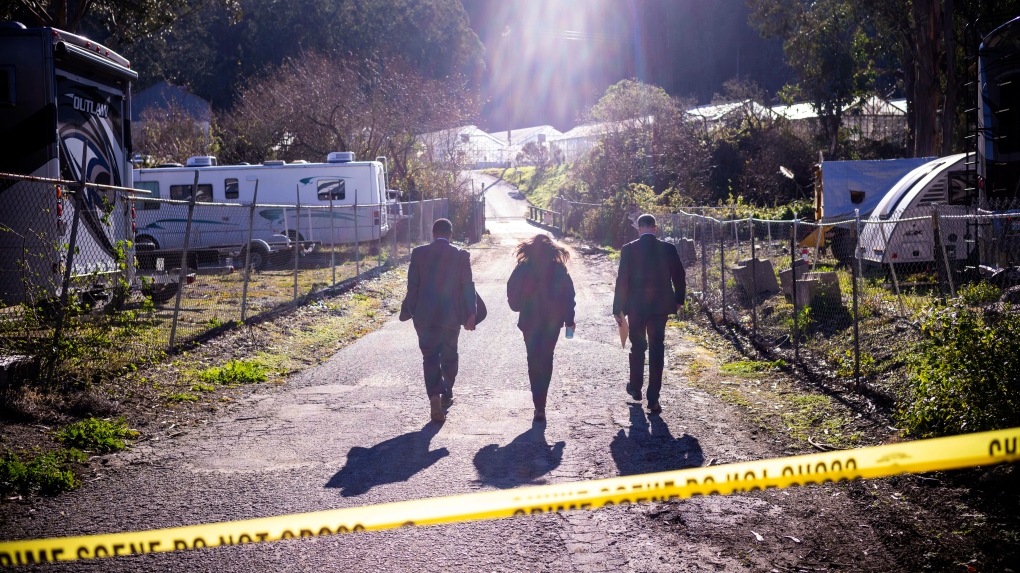 FBI officials walk towards from the crime scene at Mountain Mushroom Farm, Tuesday, Jan. 24, 2023, after a gunman killed several people at two agricultural businesses in Half Moon Bay, Calif. (AP Photo/Aaron Kehoe) 