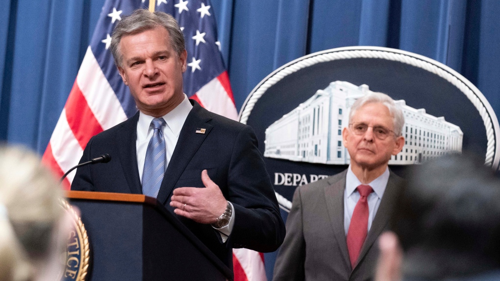 FBI Director Christopher Wray flanked by U.S. Attorney General Merrick Garland speaks during a news conference to announce an international ransomware enforcement action, Jan. 26, 2023.  (AP Photo/Jose Luis Magana)