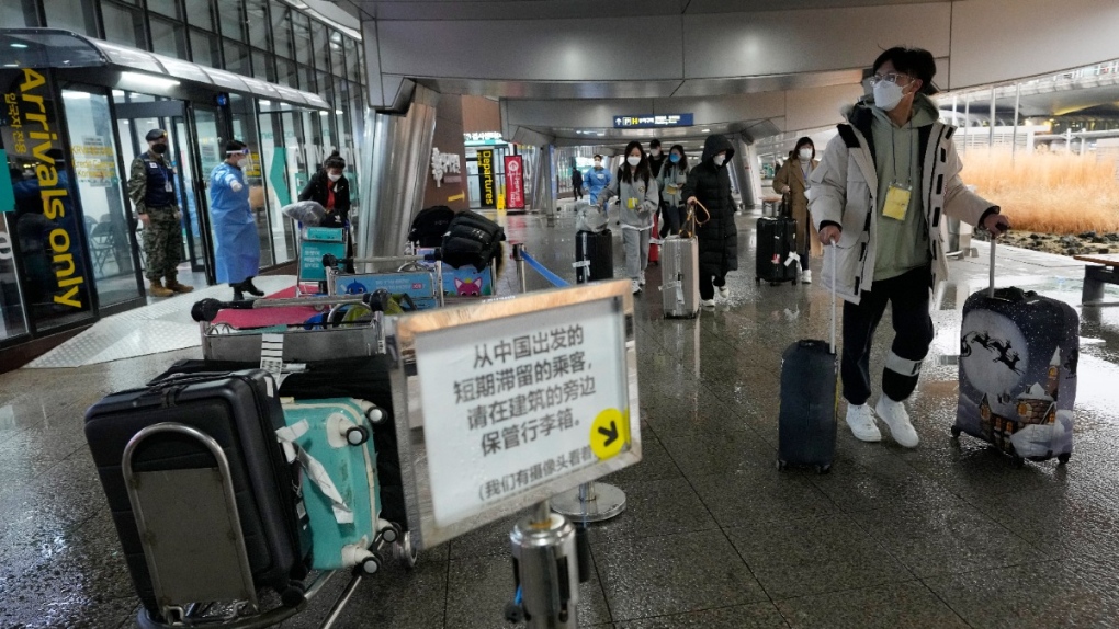 Passengers coming from China pass a COVID-19 testing centre at the Incheon International Airport in Incheon, South Korea, on Jan. 14, 2023. (Ahn Young-joon / AP) 