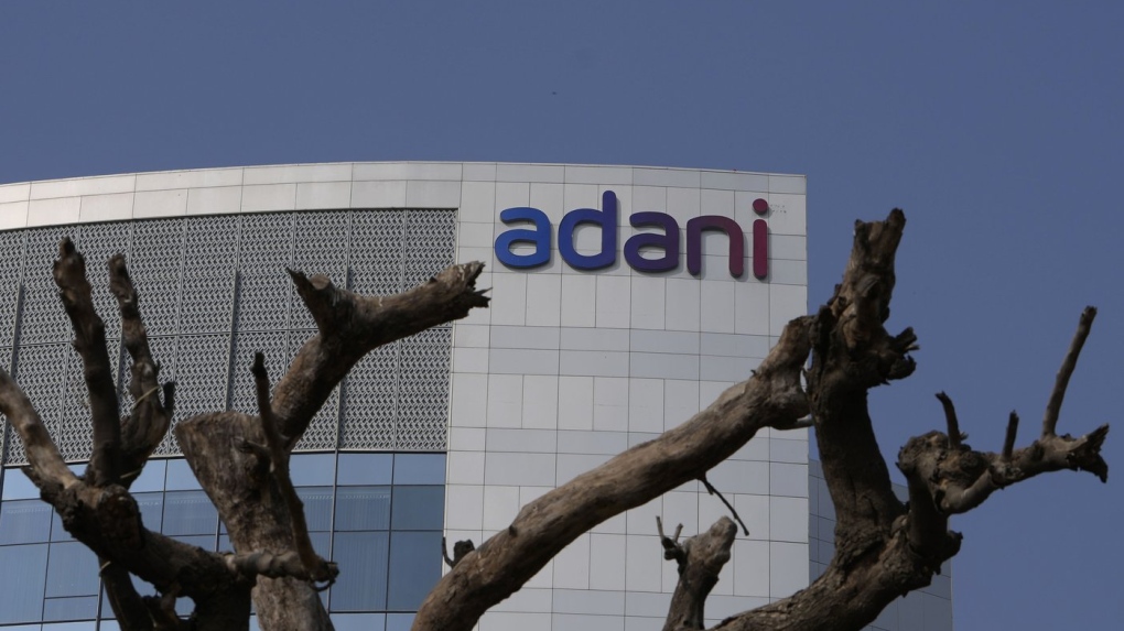 Dried branches of a tree stand outside Adani Corporate House in Ahmedabad, India, Friday, Jan. 27, 2023. (AP Photo/Ajit Solanki, File)