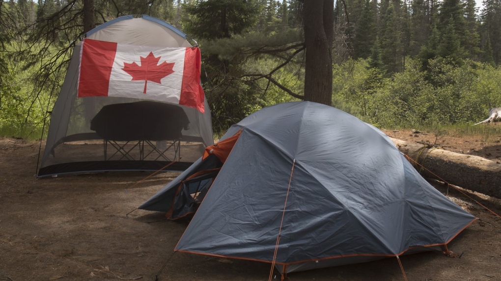 Campers with a Canadian flag are shown in Algonquin Park, June 12, 2021. THE CANADIAN PRESS/Fred Thornhill