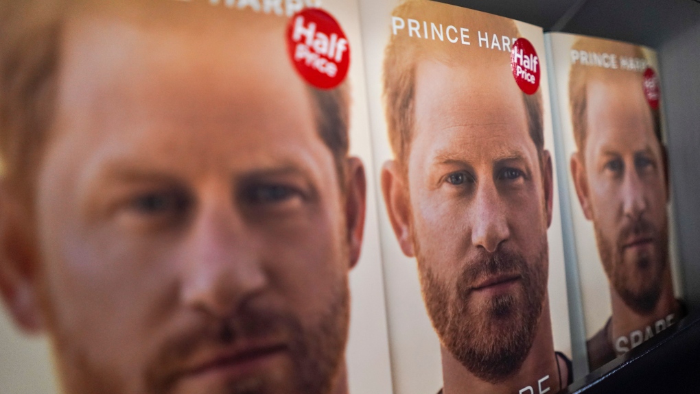 Copies of the new book by Prince Harry called "Spare" are placed on a shelf of a book store during a midnight opening in London, Tuesday, Jan. 10, 2023. Prince Harry's memoir “Spare” arrives in bookstores on Tuesday, providing a varied portrait of the Duke of Sussex and the royal family. (AP Photo/Alberto Pezzali)