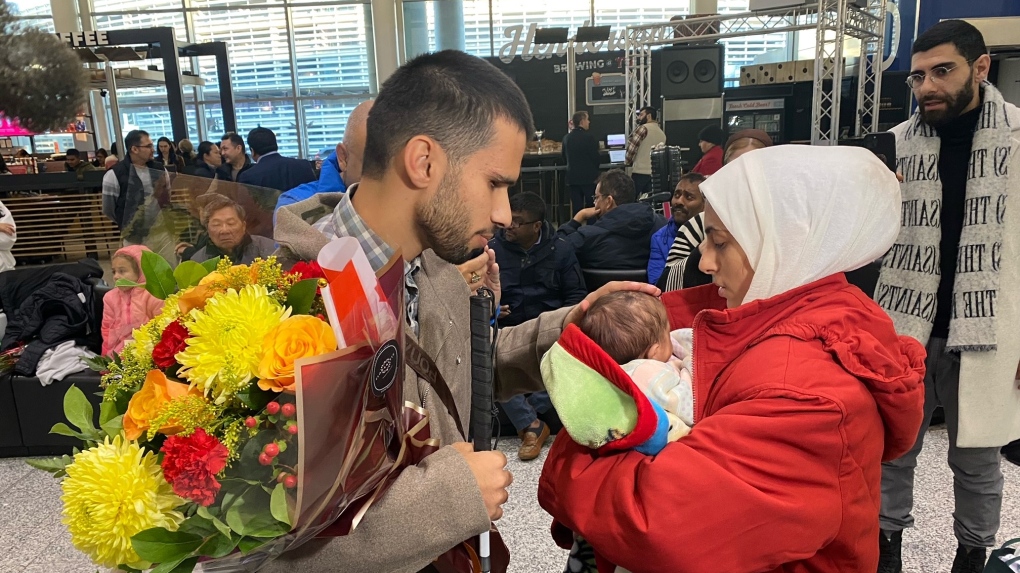 Father reunites with wife from Gaza in Toronto, touches his newborn child for the first time
