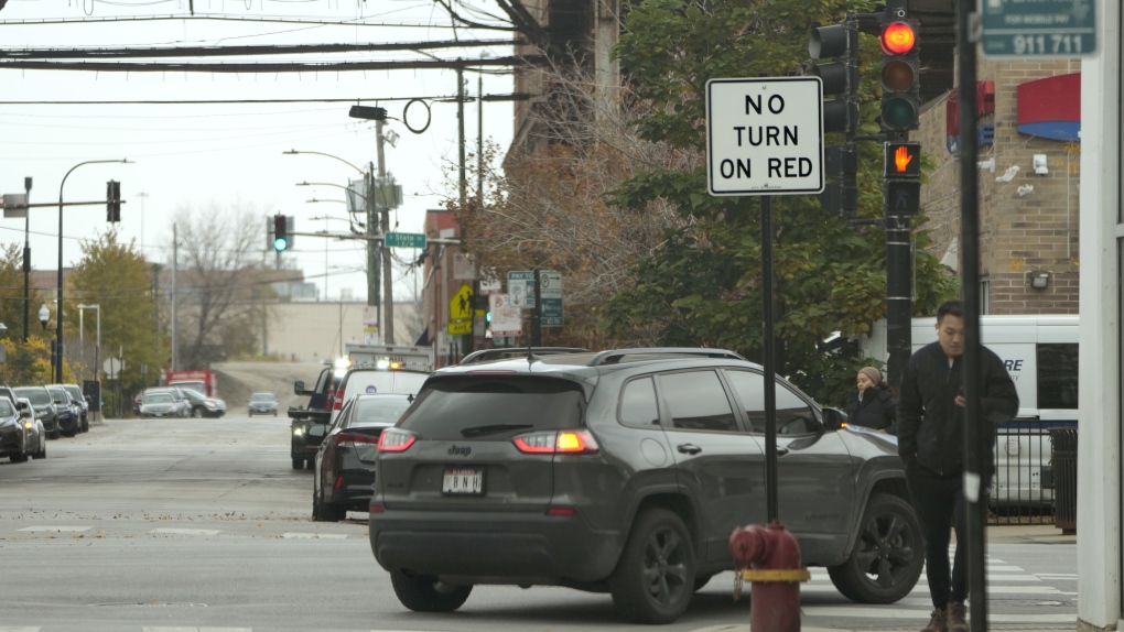 A passenger vehicle makes a right turn on red at an intersection that prohibits the turn Tuesday, Oct. 31, 2023, in Chicago. (AP Photo/Charles Rex Arbogast)