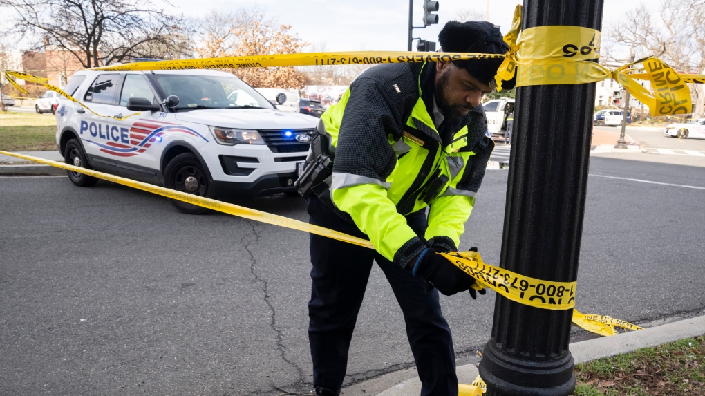 FILE - A Washington Metropolitan Police officer, puts yellow tape around the Potomac Avenue Metro Station in Southeast Washington, Feb. 1, 2023. District of Columbia Mayor Muriel Bowser's government has been struggling to handle steadily rising violent crime rates in recent years. Although police and city officials point out that overall crime rates have stayed steady, murders and carjackings have spiked — stoking public anxiety. (AP Photo/Manuel Balce Ceneta, File)