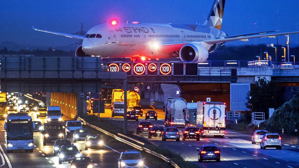In this Friday, Sept. 20, 2019 file photo, an aircraft crosses a bridge over a highway the airport in Frankfurt, Germany. (AP Photo/Michael Probst, File)