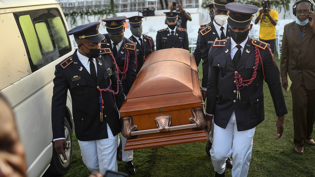 Police carry the coffin of slain Haitian President Jovenel Moise at his family home for his funeral in Cap-Haitien, Haiti, early Friday, July 23, 2021. (AP Photo/Matias Delacroix)