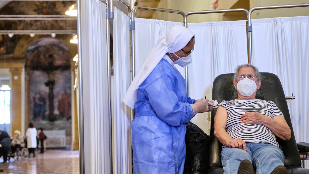 A health worker administers a dose of the Pfizer vaccine to a man at the San Giovanni Addolorata hospital, in Rome, Saturday, April 10, 2021. (Mauro Scrobogna/LaPresse via AP)