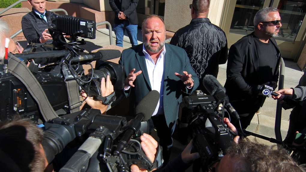 Infowars host Alex Jones speaks to the media outside Connecticut Superior Court during his Sandy Hook defamation damages trial in Waterbury, Conn., Friday, Sept. 23, 2022. (Christian Abraham/Hearst Connecticut Media via AP)