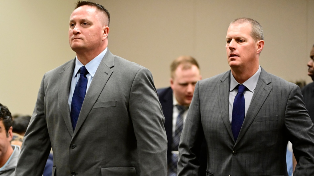 Paramedics Jeremy Cooper, left, and Peter Cichuniec, right, attend an arraignment at the Adams County Justice Center in Brighton, Colo., on Jan. 20, 2023. Opening statements are scheduled Wednesday, Nov. 29, in the third and final trial over the 2019 death of Elijah McClain, who died after he was stopped by police in suburban Denver. Jurors will have to decide if the two paramedics committed a crime when they gave the 23-year-old Black man an overdose of the sedative ketamine after he was forcibly restrained by officers in Aurora. (Andy Cross/The Denver Post via AP, File)