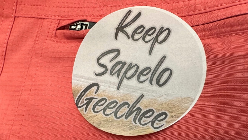A sticker saying "Keep Sapelo Geechee" is worn on the shirt of George Grovner, a resident of the Hogg Hummock community on Sapelo Island, during a meeting of McIntosh County commissioners, Sept. 12, 2023, in Darien, Ga. County commissioners in Georgia are asking a judge to throw out a lawsuit by Black residents descended from slaves who fear new zoning changes will force them to sell their island homes in one of the South's last surviving Gullah-Geechee communities. (AP Photo/Ross Bynum, File)
