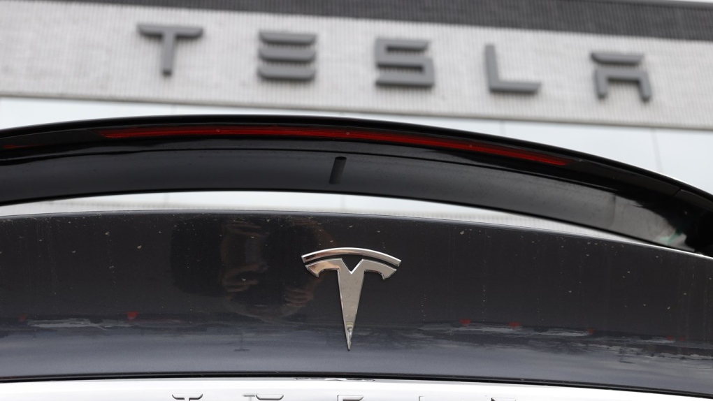 The Tesla company logo shines off the rear deck of an unsold 2020 Model X at a Tesla dealership, April 26, 2020, in Littleton, Colo. (AP Photo/David Zalubowski, File)