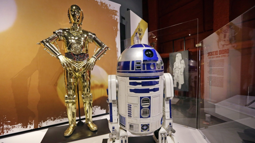 In this photo taken Thursday, Jan. 29, 2015, C-3PO, left, and R2-D2 costumes are displayed as part of an exhibit on the costumes of Star Wars at Seattle’s EMP Museum. (AP Photo/Elaine Thompson/File)