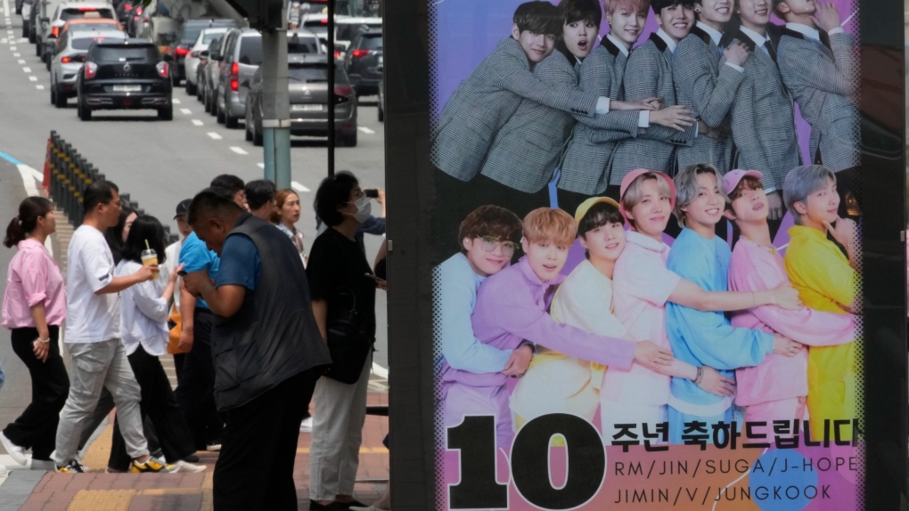 A poster showing K-pop band BTS members is displayed to celebrate its 10th debut anniversary at a bus station in Seoul, South Korea, on June 14, 2023. (AP Photo/Ahn Young-joon, File)