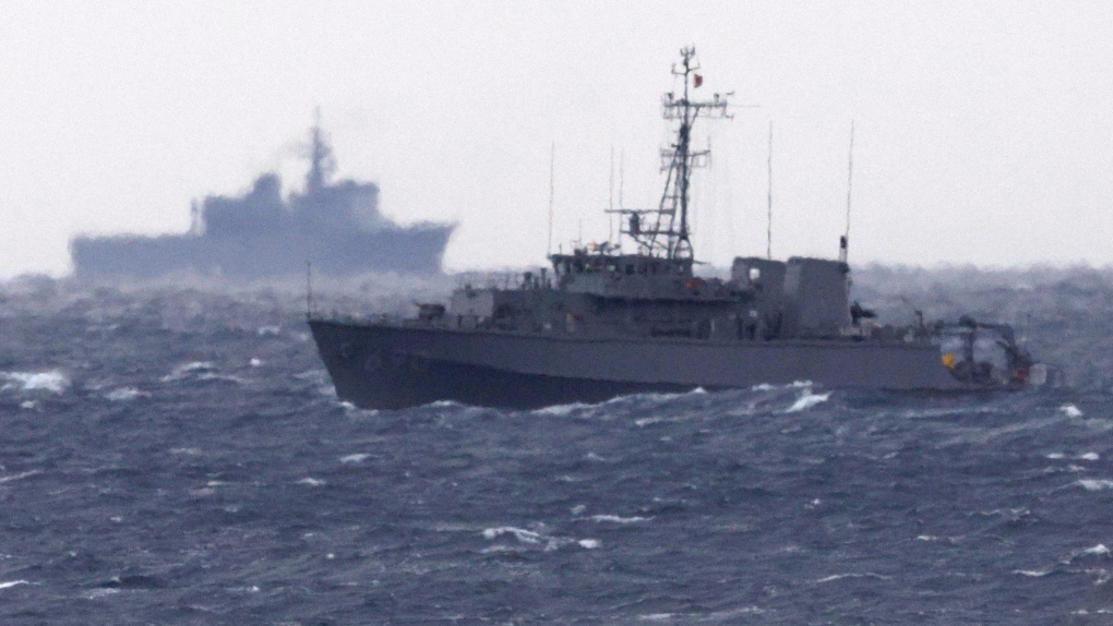 A Japanese Maritime Self Defense Force minesweeper searches in the waters where a U.S. military Osprey aircraft crashed, off Yakushima, Kagoshima prefecture, southern Japan, Friday, Dec. 1, 2023. Japan suspended flights by its Osprey aircraft Thursday, officials said, the day after the U.S. Air Force Osprey based in Japan crashed into the sea during a training mission. (Kyodo News via AP)