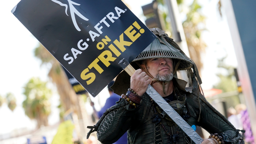 SAG-AFTRA member Bruce D. Mitchell participates in a post apocalyptic-themed picket line outside Netflix studios, Nov. 8, 2023, in Los Angeles. Hollywood’s actors have voted to ratify the deal with studios that ended their strike after nearly four months, leaders announced Tuesday, Dec. 5, 2023. (AP Photo/Chris Pizzello, File)