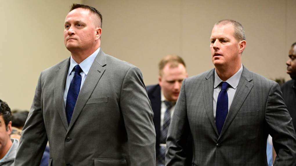 Paramedics Jeremy Cooper, left, and Peter Cichuniec attend an arraignment at the Adams County Justice Center in Brighton, Colo., on Jan. 20, 2023. The two paramedics on trial over the 2019 death of Elijah McClain told investigators in videotaped interviews previously unseen by the public that the 23-year-old Black man had "excited delirium,” a disputed condition that some say is unscientific and rooted in racism. (Andy Cross/The Denver Post via AP, File)
