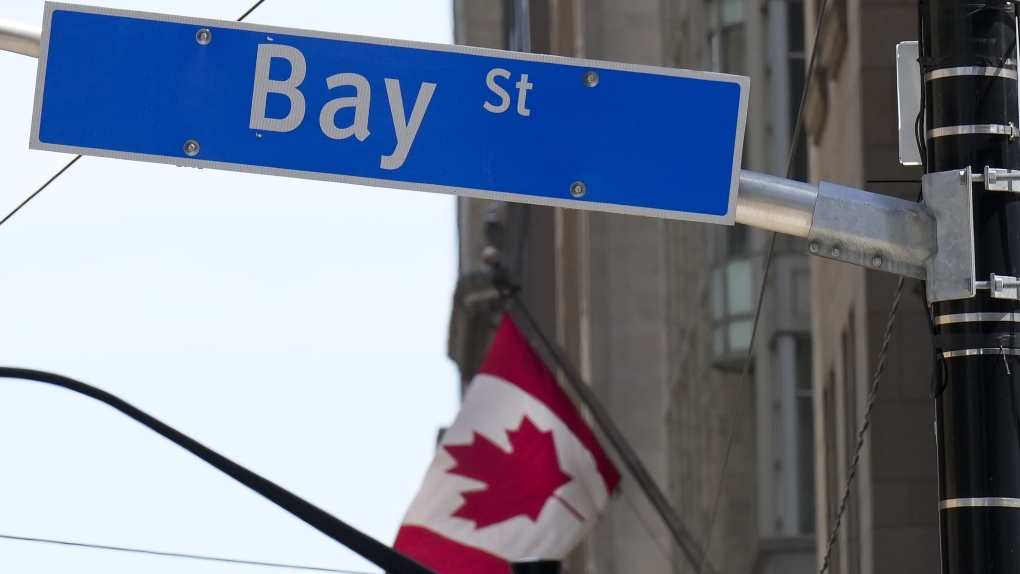 The Bay Street Financial District is shown with the Canadian flag in Toronto on Friday, August 5, 2022. (THE CANADIAN PRESS/Nathan Denette)