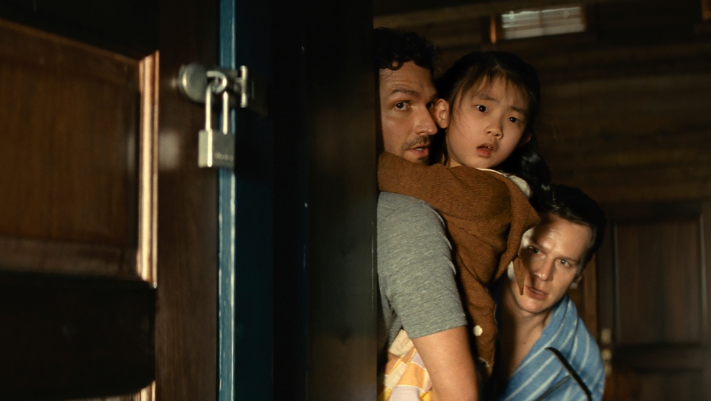 Movie reviews: ‘Knock at the Cabin’ wastes an interesting cast and premise with a hollow story