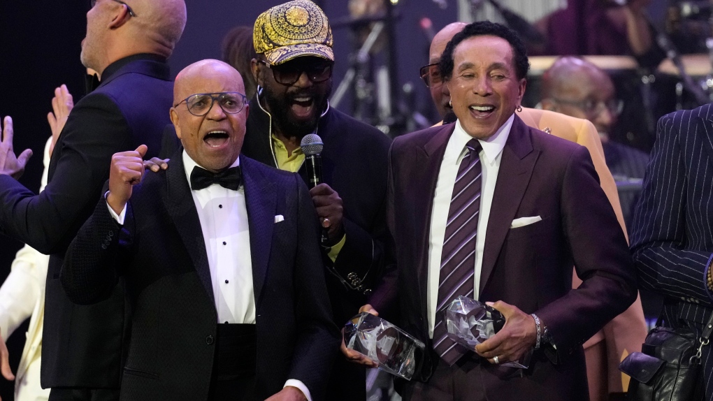 Berry Gordy, left, and Smokey Robinson, right, accept their MusiCares Person of the Year awards at a celebration in their honor at the Los Angeles Convention Center on Friday, Feb. 3, 2023. (AP Photo/Chris Pizzello)