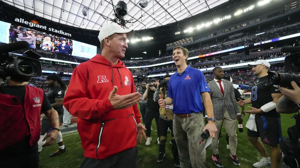 AFC coach Peyton Manning, left, jokes with NFC coach Eli Manning after the flag football event at the NFL Pro Bowl, Feb. 5, 2023, in Las Vegas. (AP Photo/John Locher)