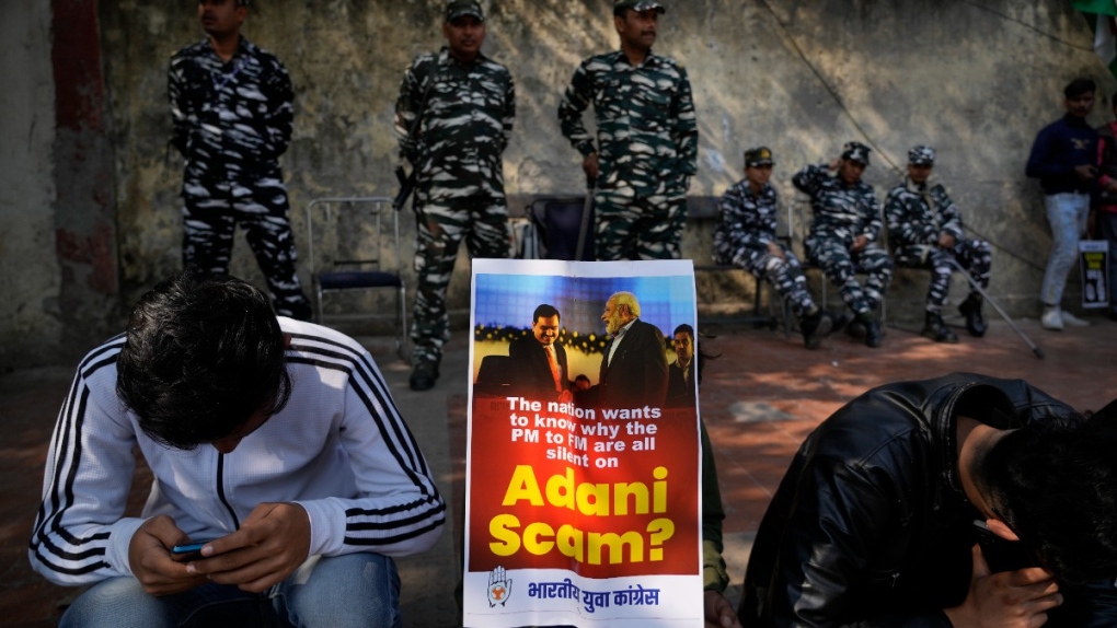 A placard with images of Indian businessman Gautam Adani and Indian Prime Minister Narendra Modi during a protest in New Delhi, India, on Feb.6, 2023. (Manish Swarup / AP) 